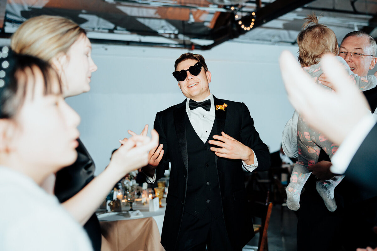 Groomsman dancing at wedding reception