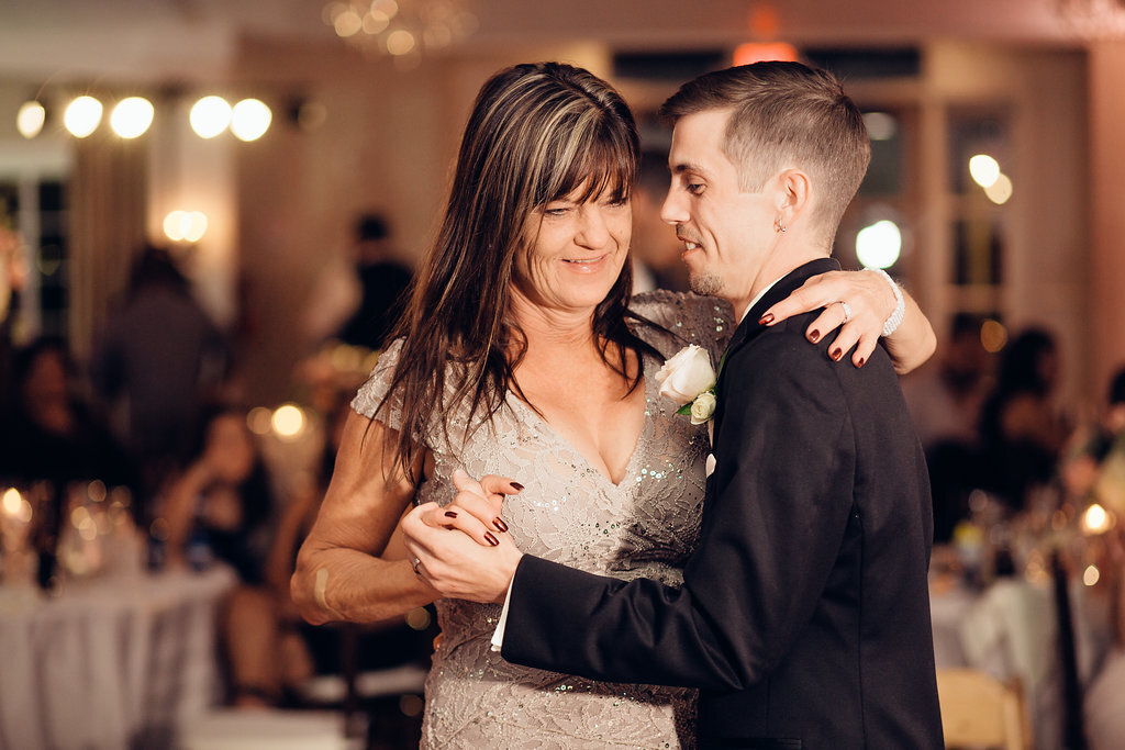 Wedding Photograph Of Groom In Black Suit Dancing With a Woman In Light Brown Dress Los Angeles
