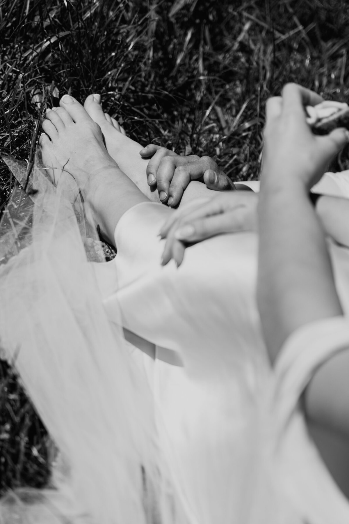 Close-up of bare feet resting on grass during picnic