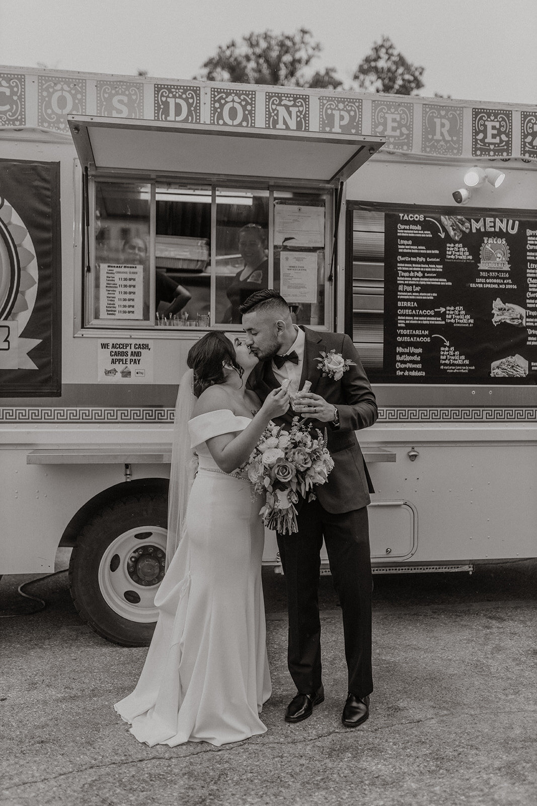 Photo of wedding couple kissing outside