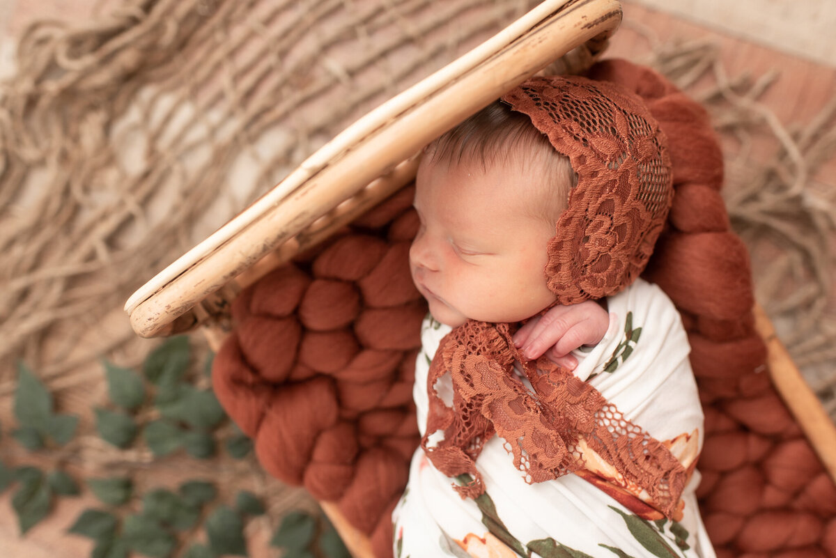 Close up of baby girl in fall floral at indoor studio session in Canton, CT