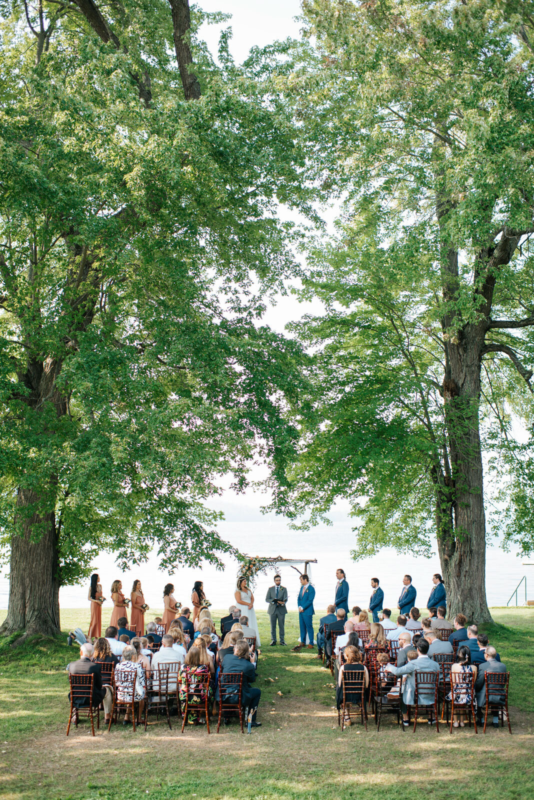 microwedding ceremony at lake bomoseen lodge under trees in vermont