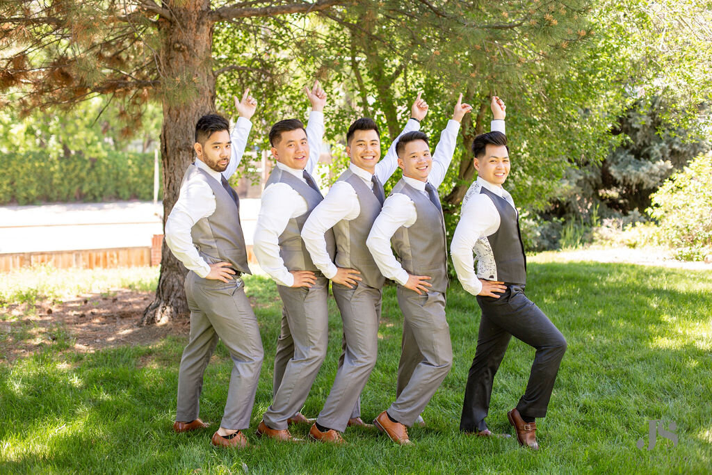 Groom and groomsmen pose together in a silly photo.