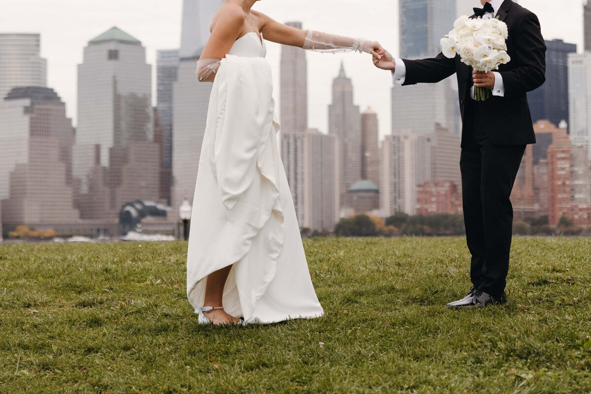A bride and groom in front of the NYC skyline