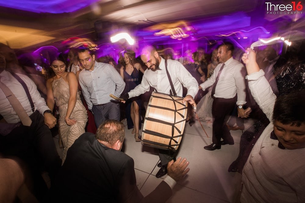 Guest banging a drum on the dance floor
