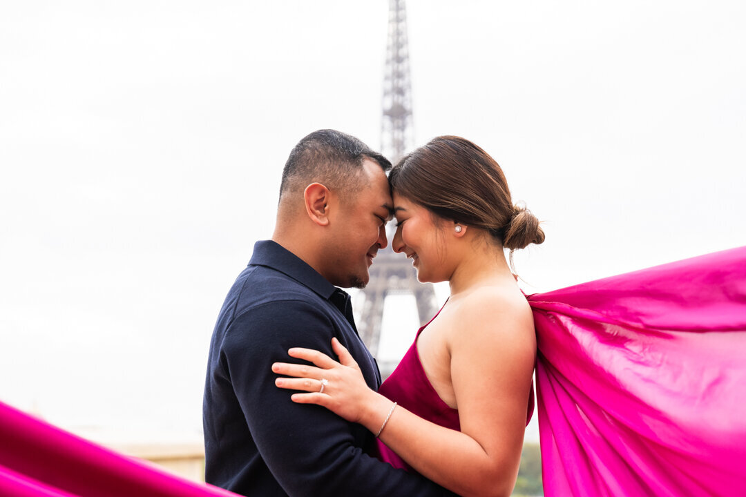 Intimate forehead touch couple portrait, Eiffel Tower framed between, romantic Paris photography