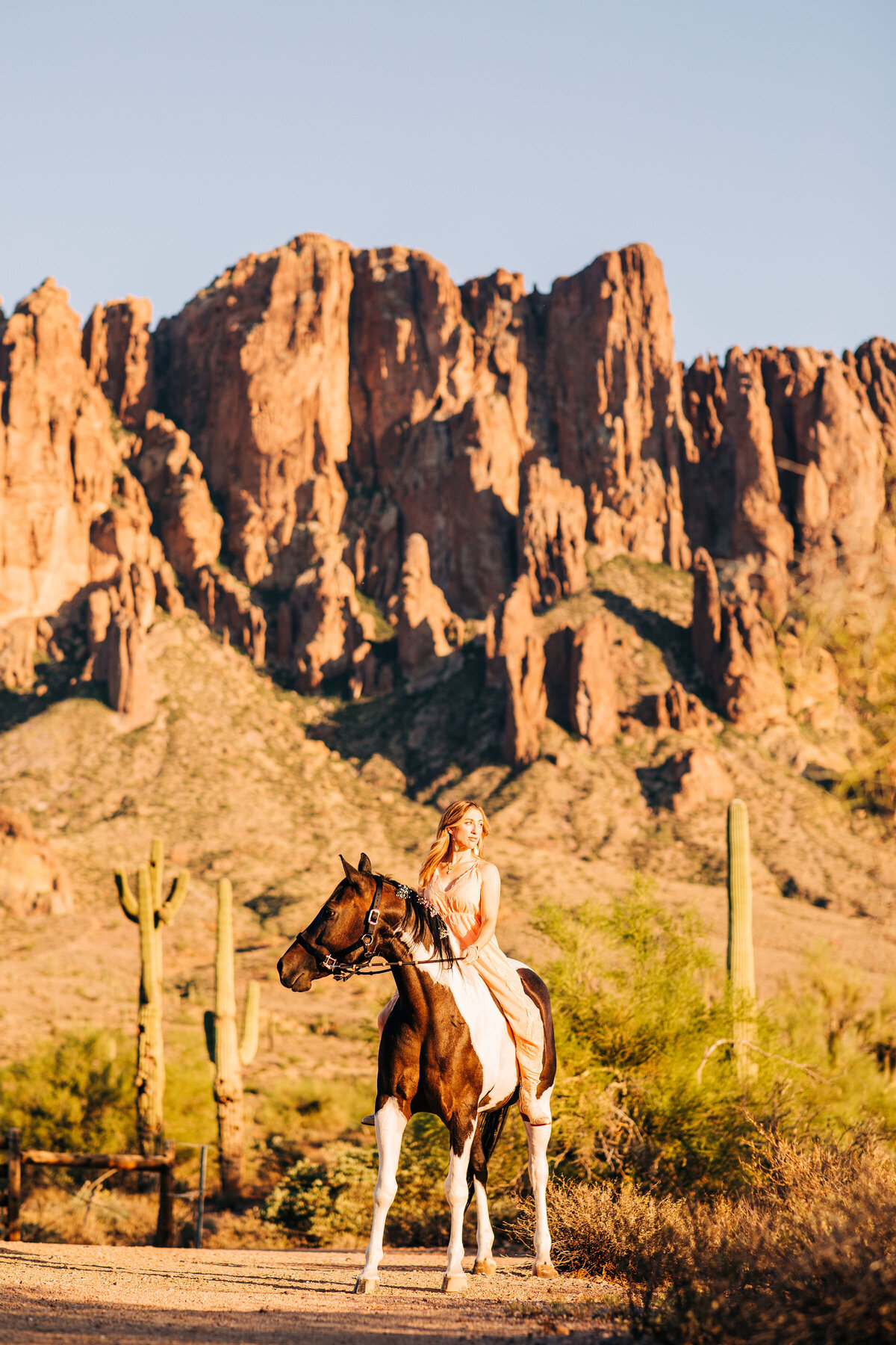 woman on horse with mountains in background