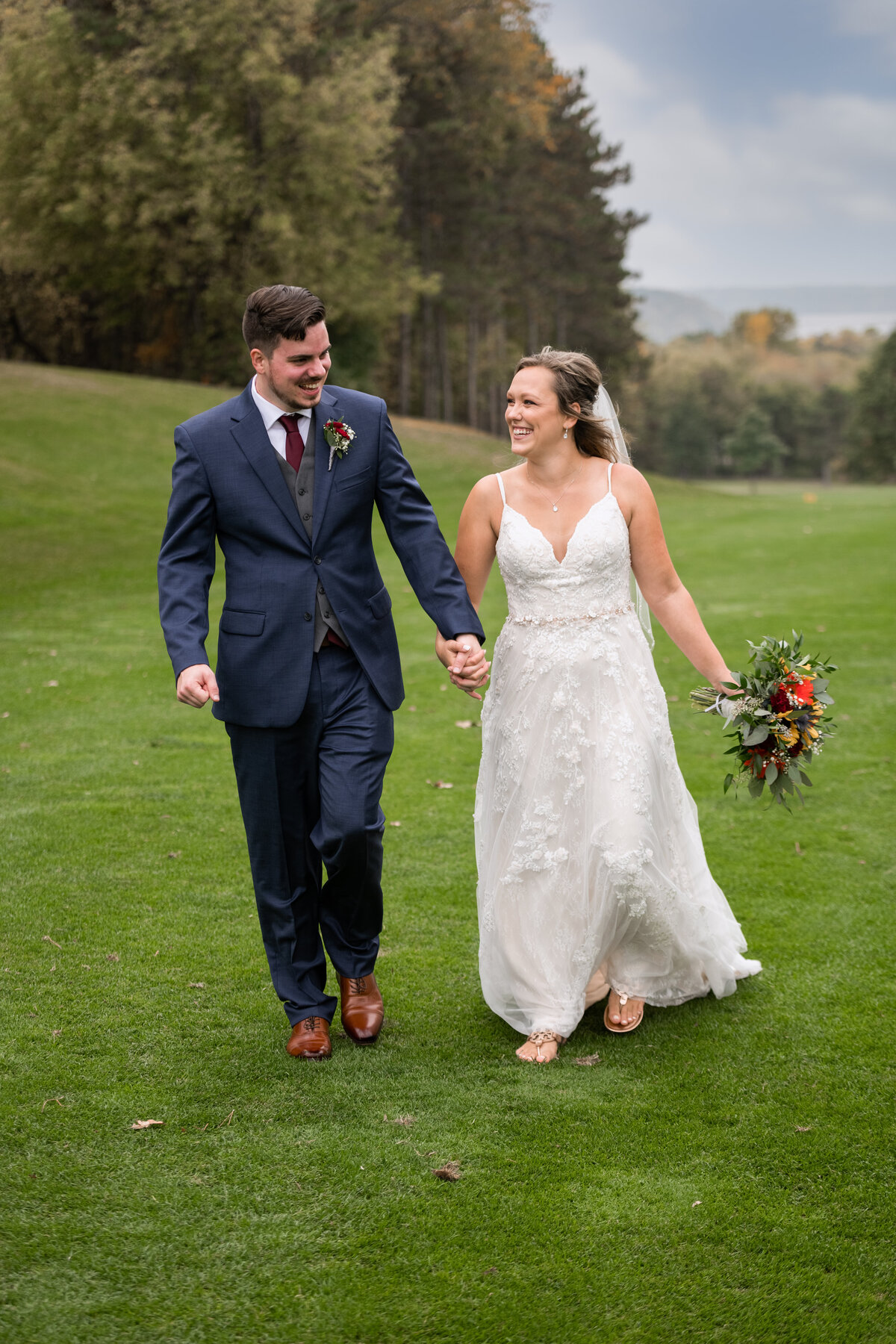Wedding couple smiling and walking on a golf course