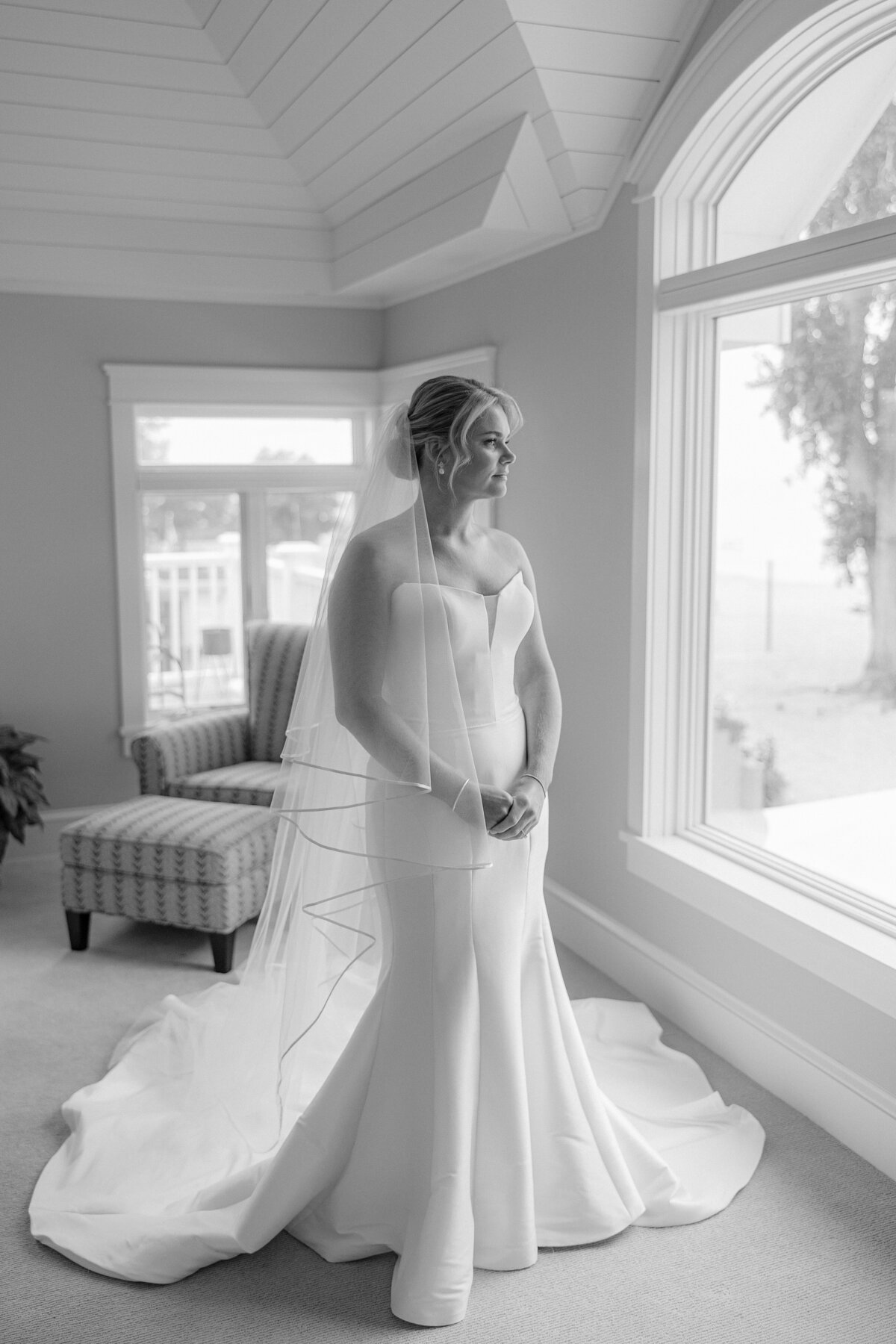 portrait of a bride in a lakehouse on Lake Ontario in traditional wedding gown
