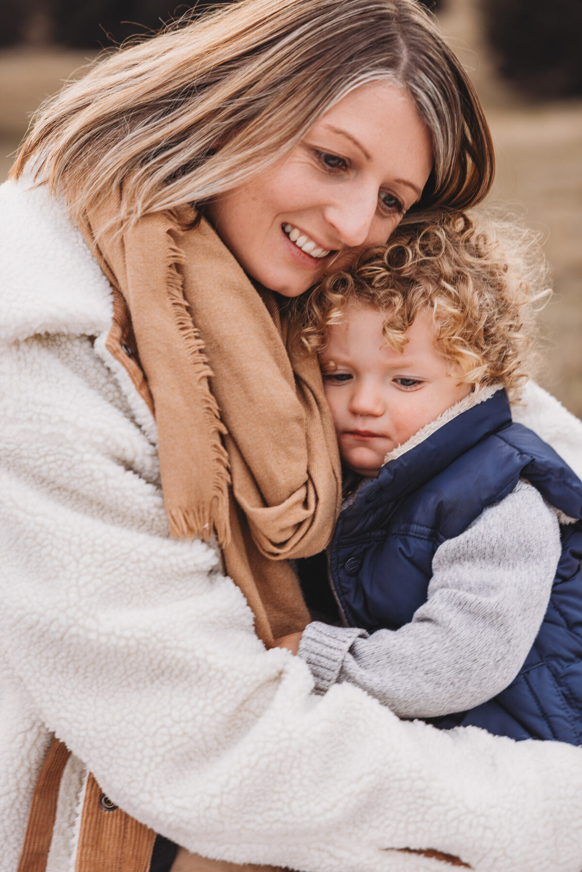 a mum giving cuddles to her son captured during a wanaka family photography session