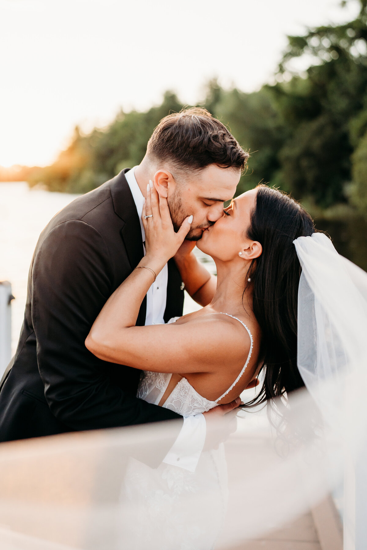 Bride and groom portrait with veil in the wind at golden hour just south of Boston Massachusetts East Coast photographer