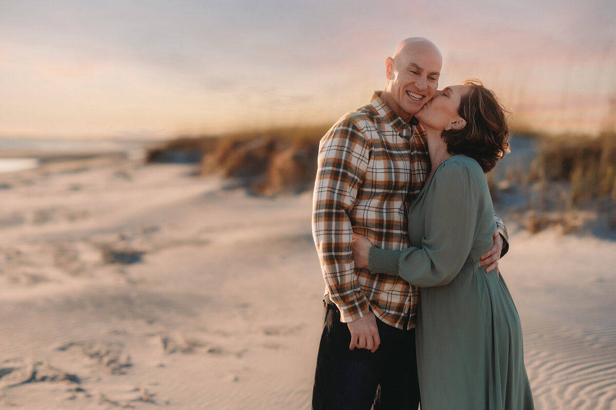 Wife kisses her husband during Family Photos on Kiawah Island.