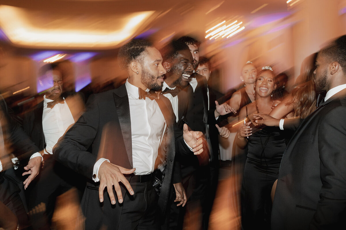black groomsman dancing at wedding reception