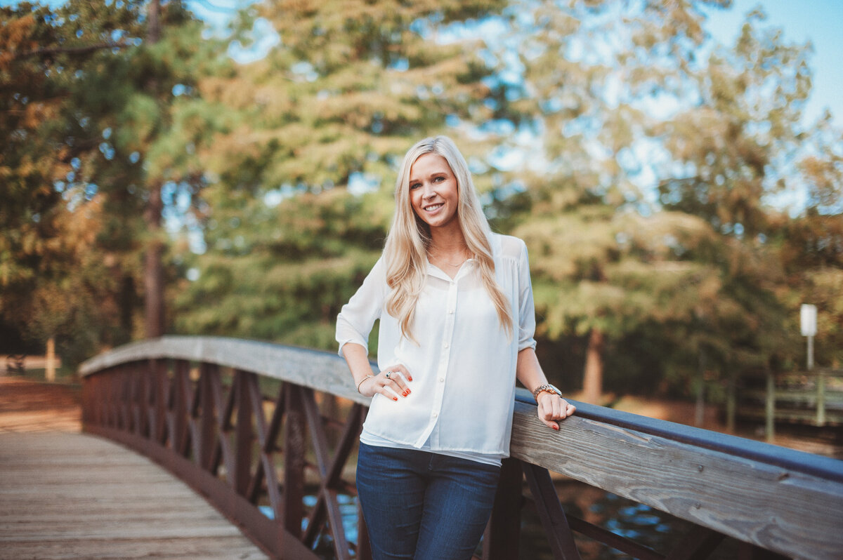 Woman standing among yellow wildflowers during a bright outdoor portrait session in Winter Garden, Florida.