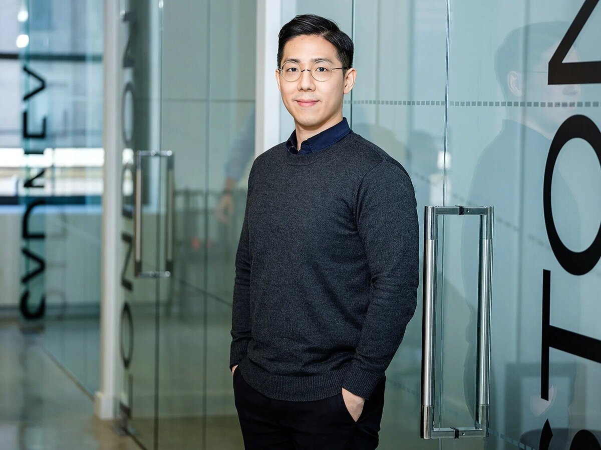 NYC corporate headshot of young professional man in modern office environment
