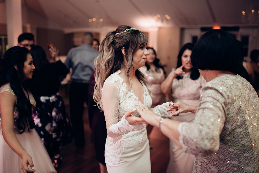 Wedding Photograph Of Bride Dancing With a Woman In Light Brown Blouse Los Angeles