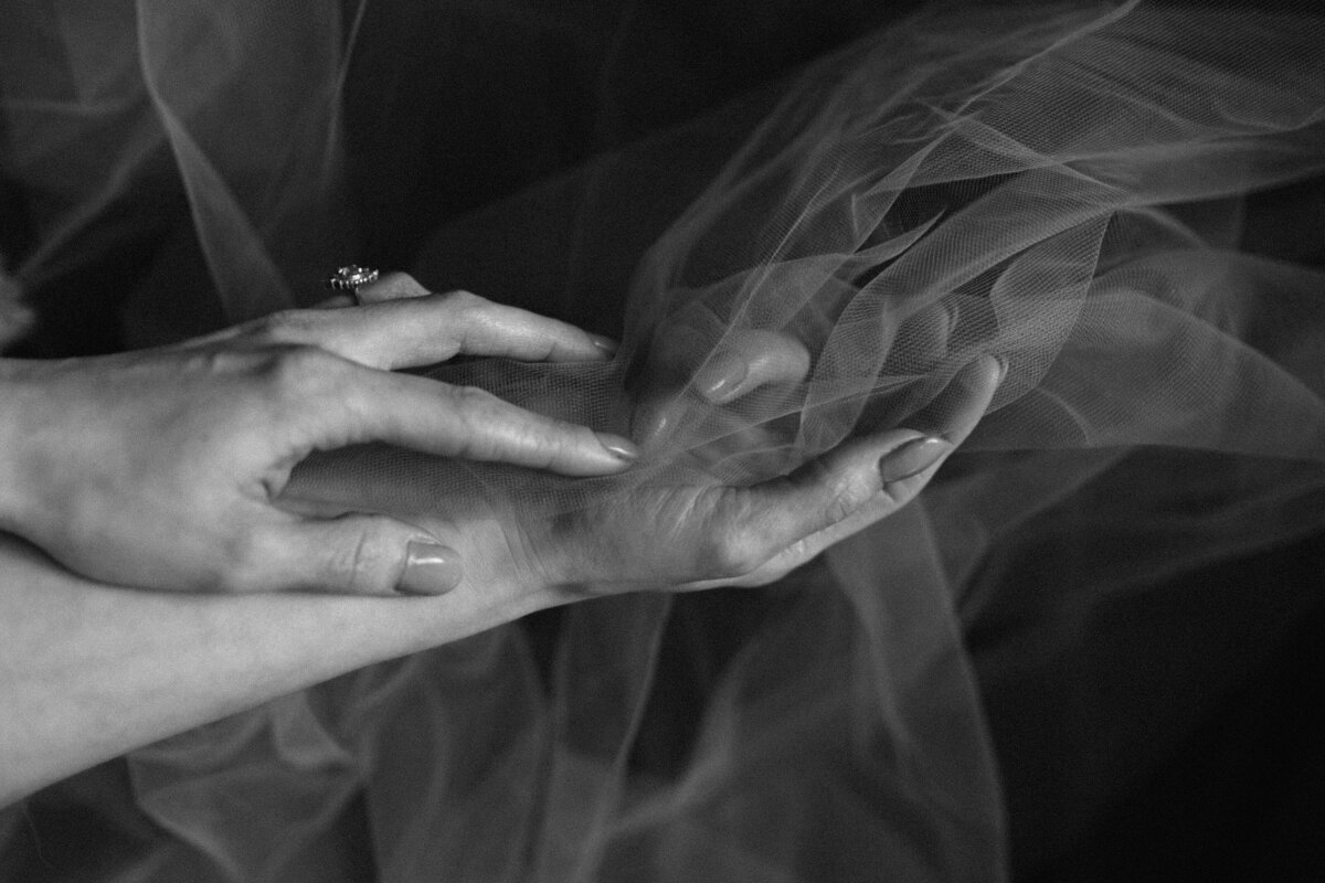 black and white image hands holding fabric