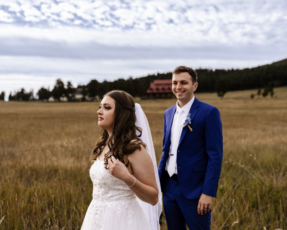 bride and groom in field
