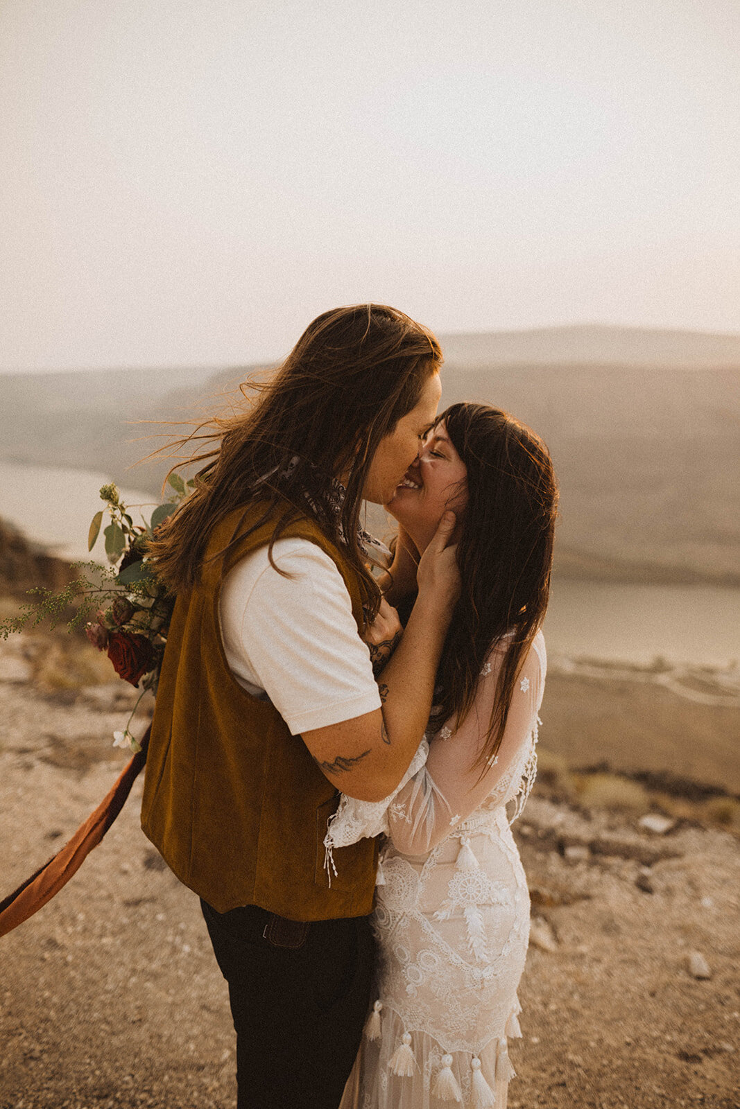 idaho elopement gallery page lgbt brides kissing after their elopement ceremony at snake river canyon