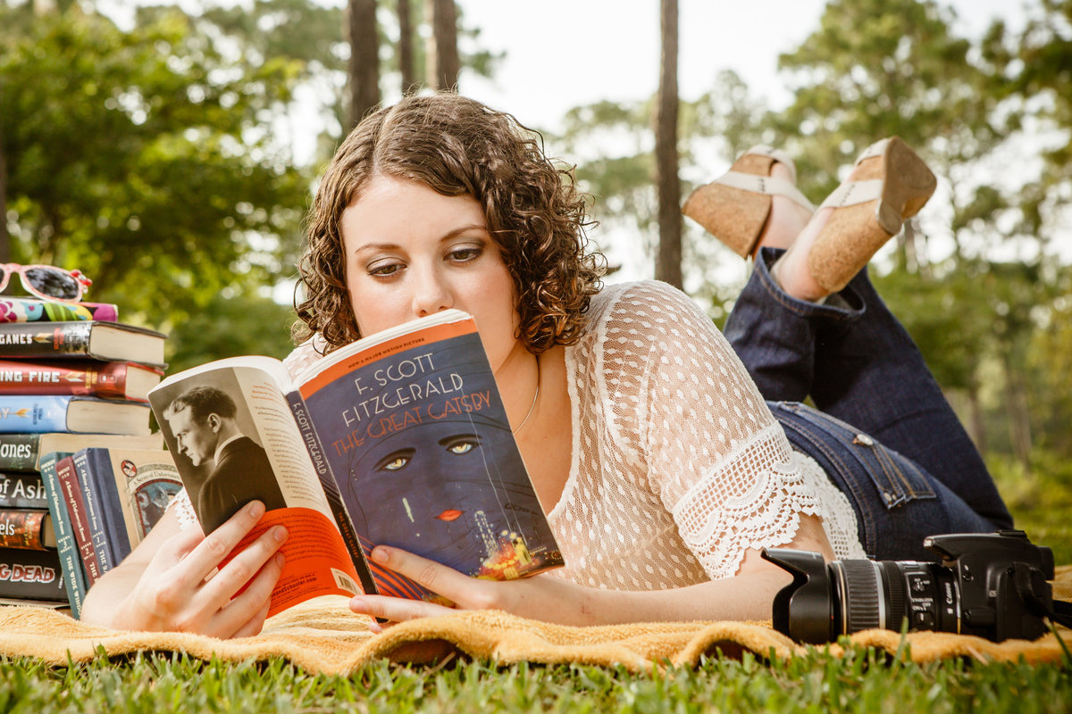 Senior portrait of Madison DeHart in Theodore, Alabama reading books.