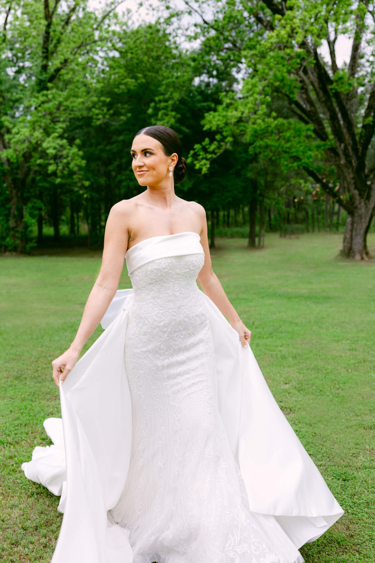 A wedding day portrait photo of the bride in her white wedding dress