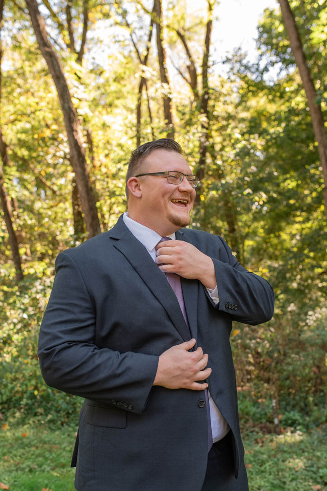 Indiana-wedding-photography-groom-smiles-fixes-tie