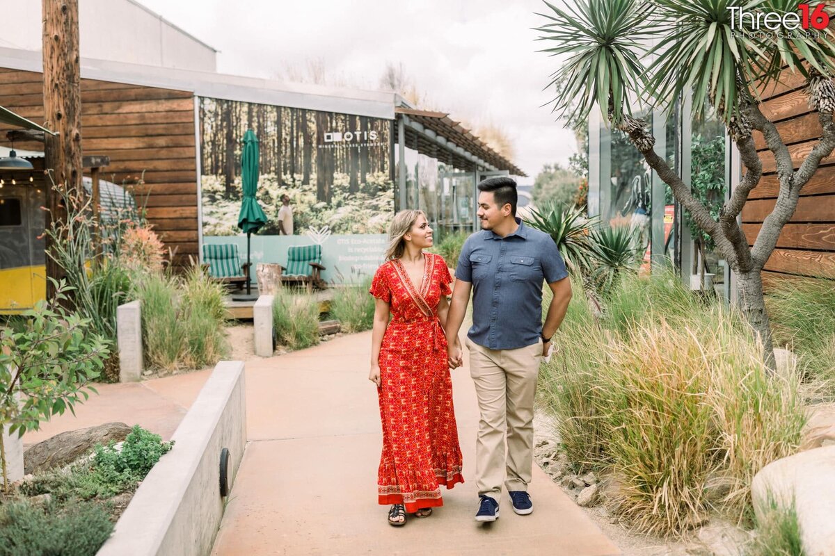 Engaged couple go for a walk through The CAMP in Costa Mesa