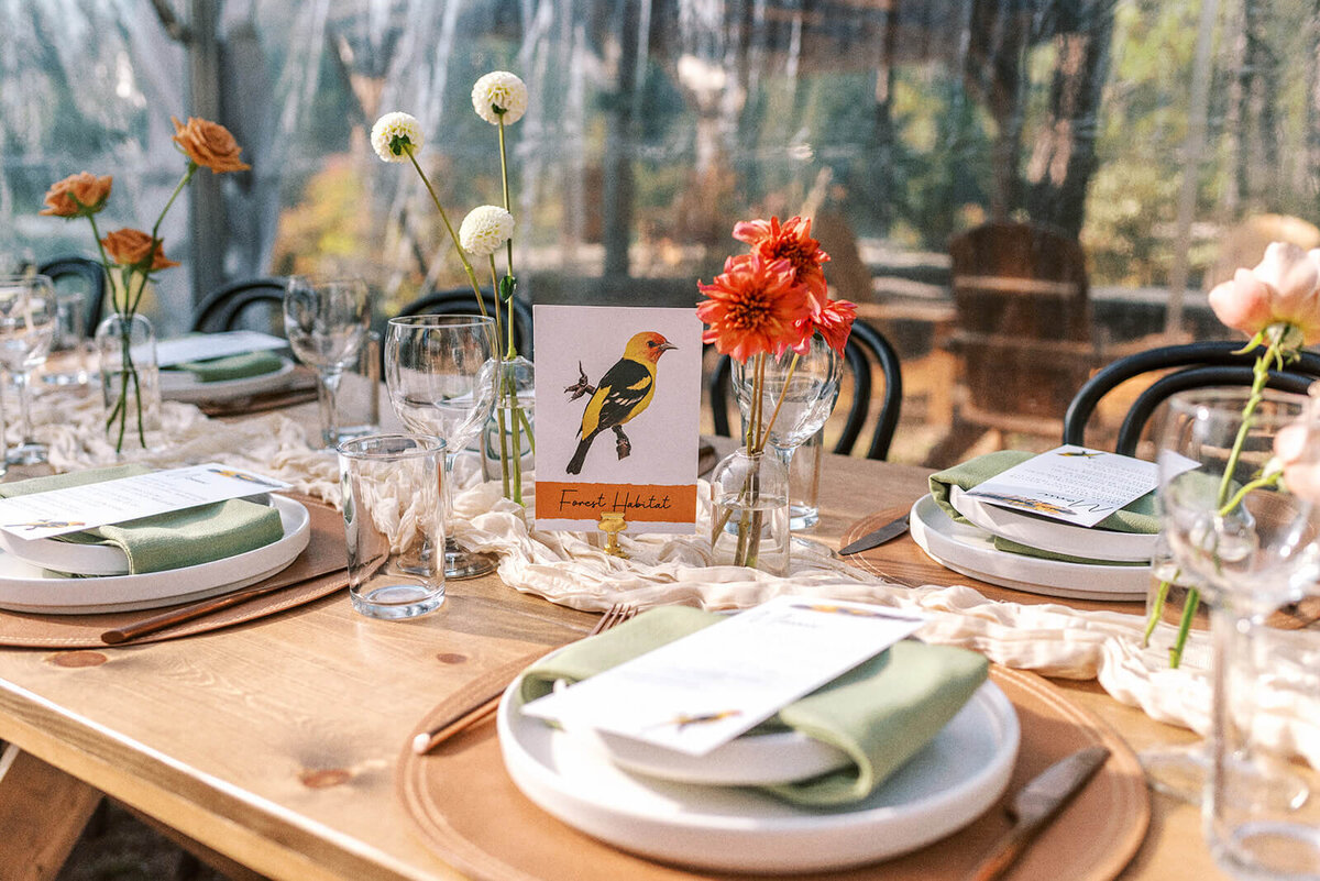 A close up of a table setting at an outdoor wedding reception at Suttle Lake Lodge.