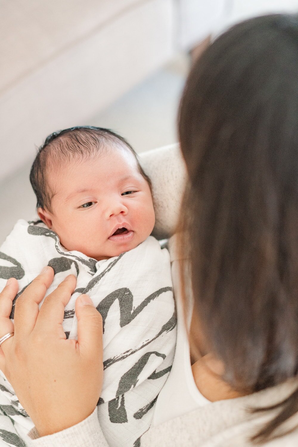 baby held by mom during Manassas, VA lifestyle newborn photography