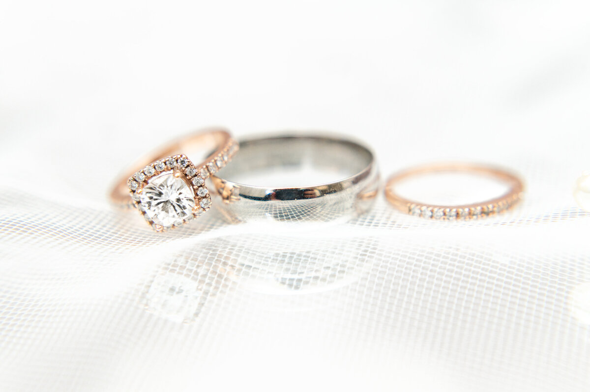 close up photo of wedding rings and wedding band