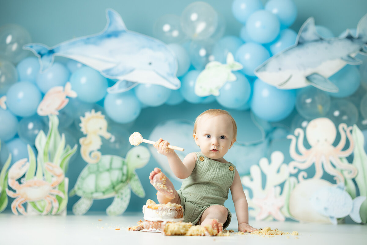 Baby boy with shark and ocean themed first birthday cake smash in Canton GA studio