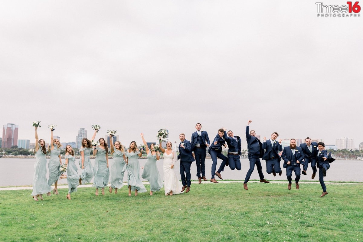 Bride and Groom join the wedding party and jump in the air for pure joy