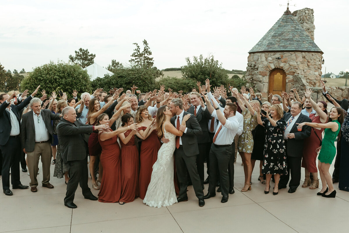 Bride and groom kiss with all of their guests at Cherokee Ranch and Castle.