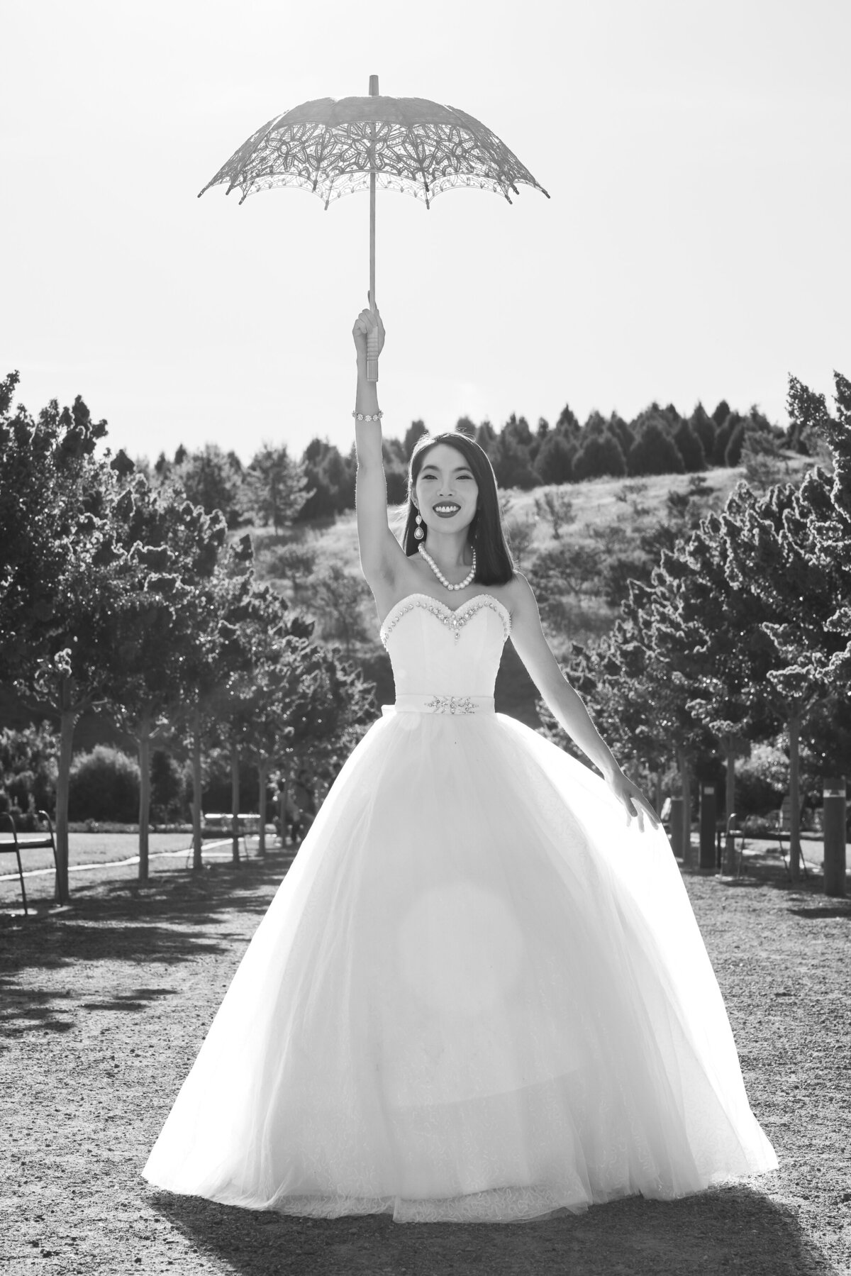 Bride outdoors holding parasol