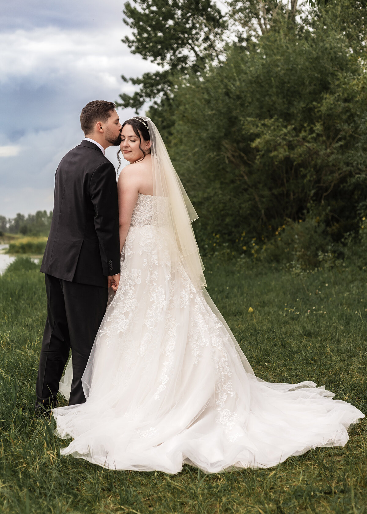 groom-kisses-brides-temple-portrait