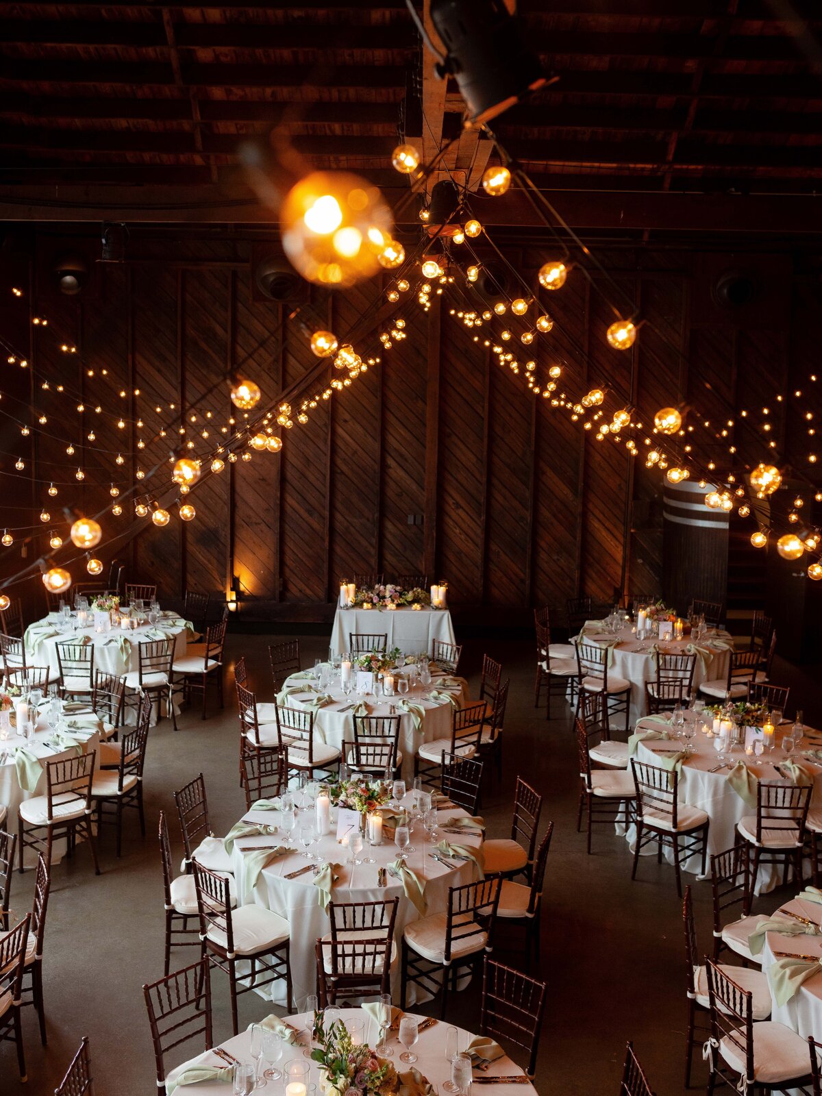 Twinkly lights above a wedding reception space at Saltwater Farms Vineyard.