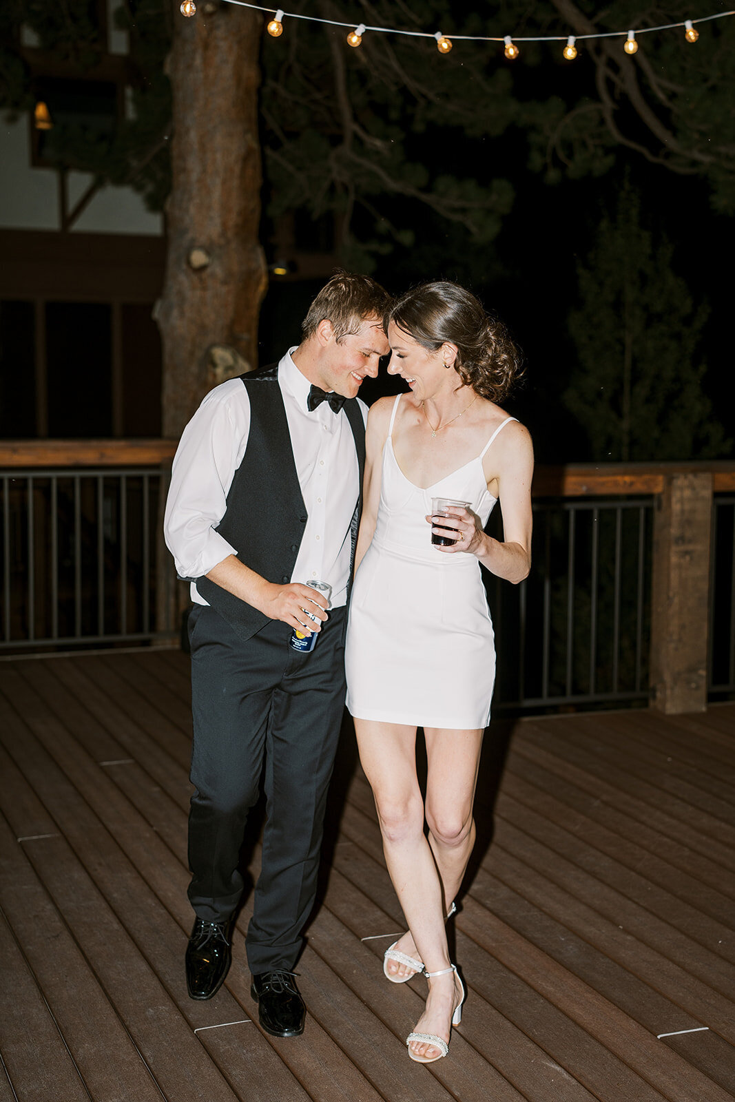 Bride and groom share a moment in their wedding after party outfits at the Landing in Estes Park.