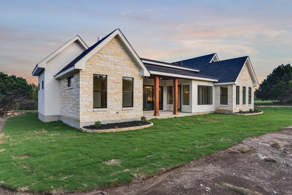 limestone texas hill country houses with wood columns at back porch