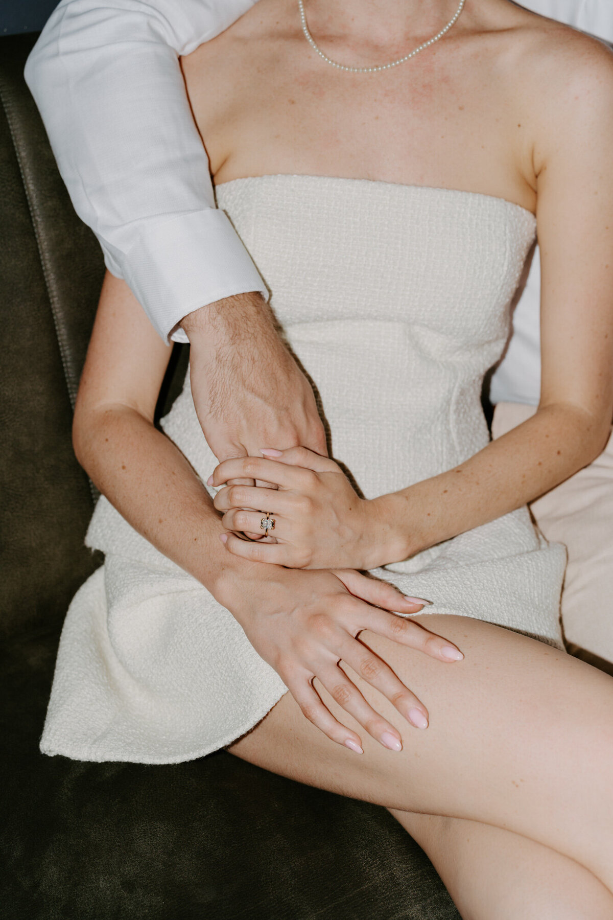 engaged couple holding hands
