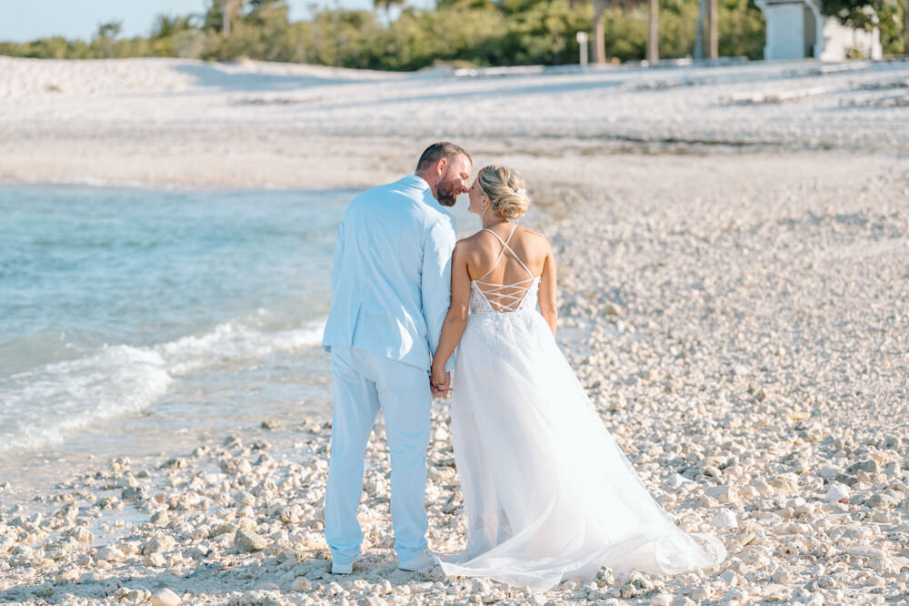 a bride and groom on the beach in the Bahamas
