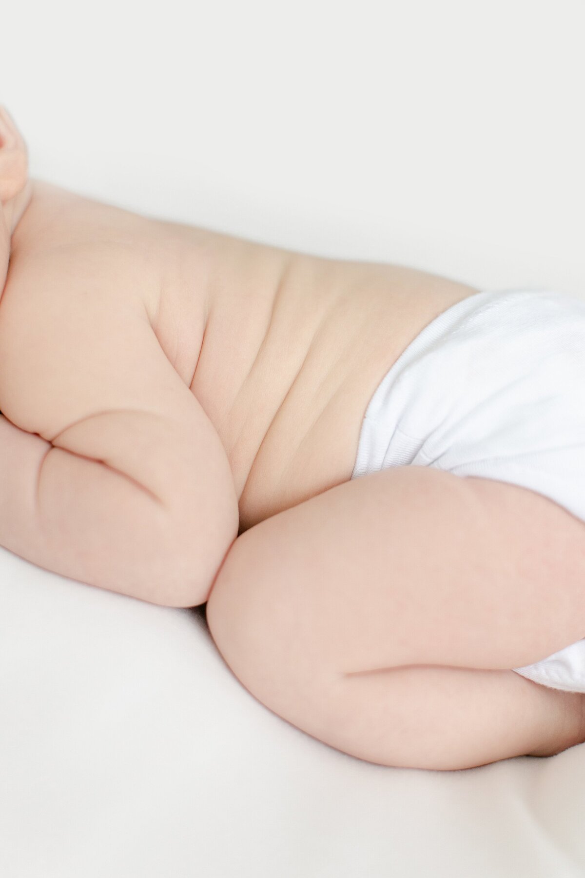 clost up of newborn side rolls