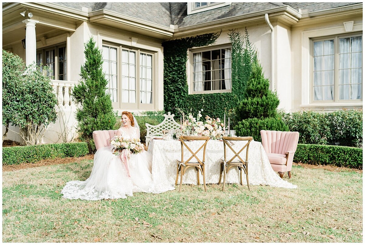 Bride sitting at decorated table outside
