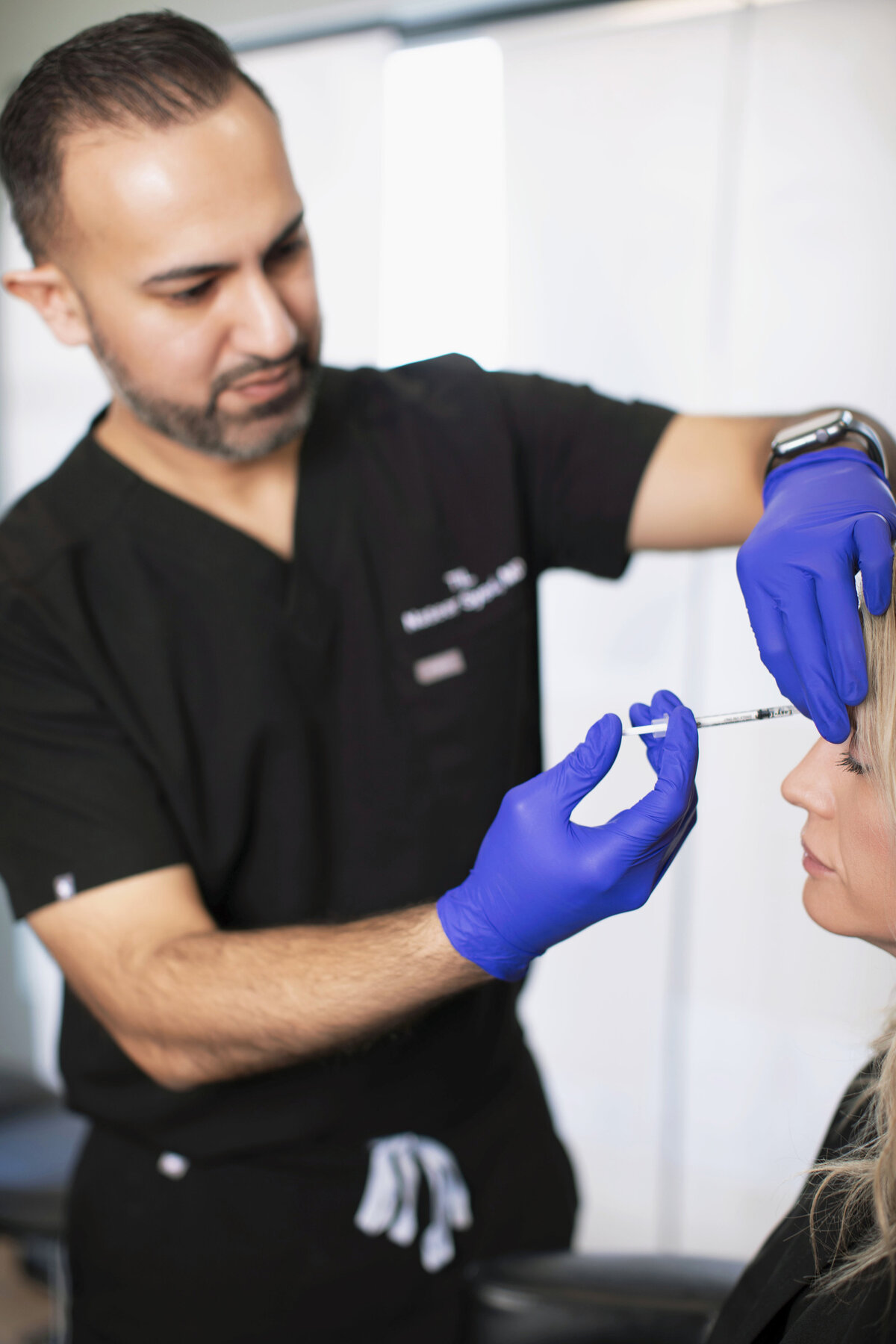 Client receiving honest aesthetic advice from Dr. Syed during pre-treatment consultation