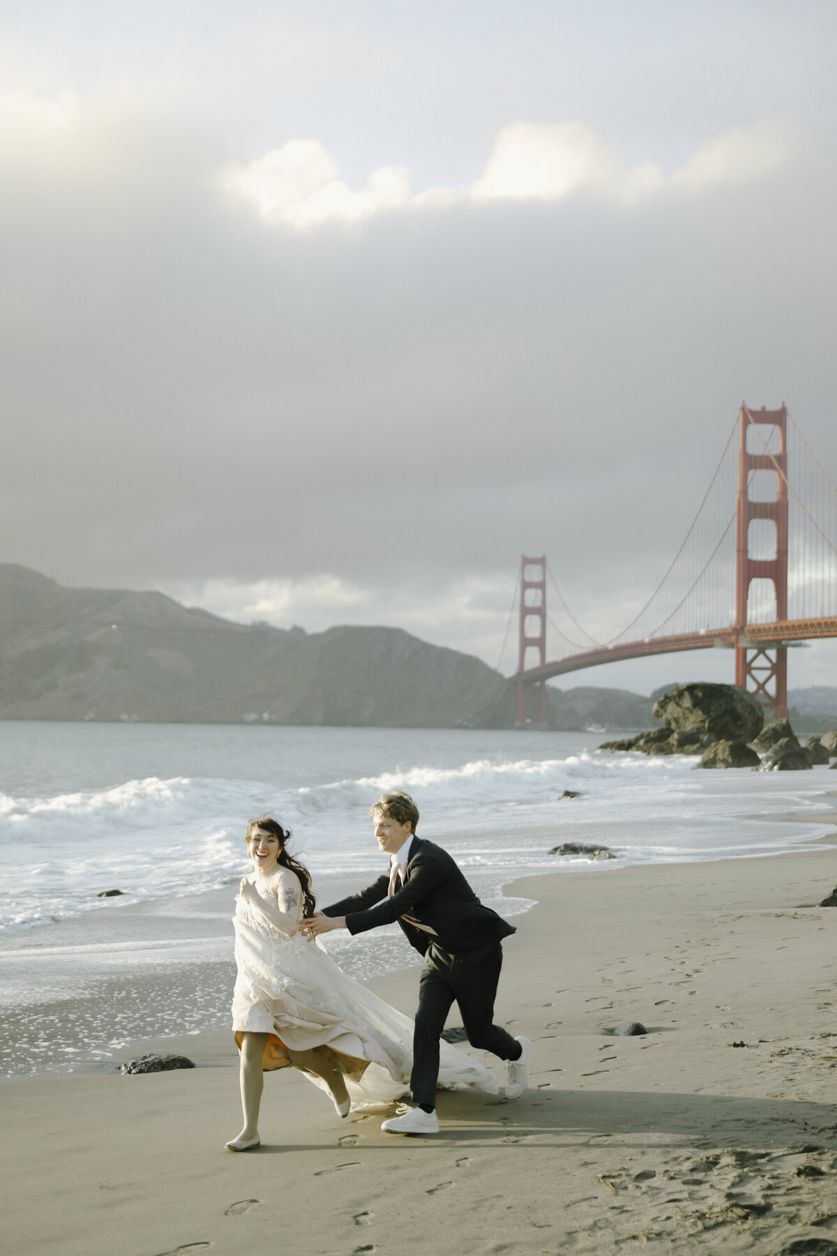 Bride and Groom at Marshall's Beach in San Francisco, California at sunset