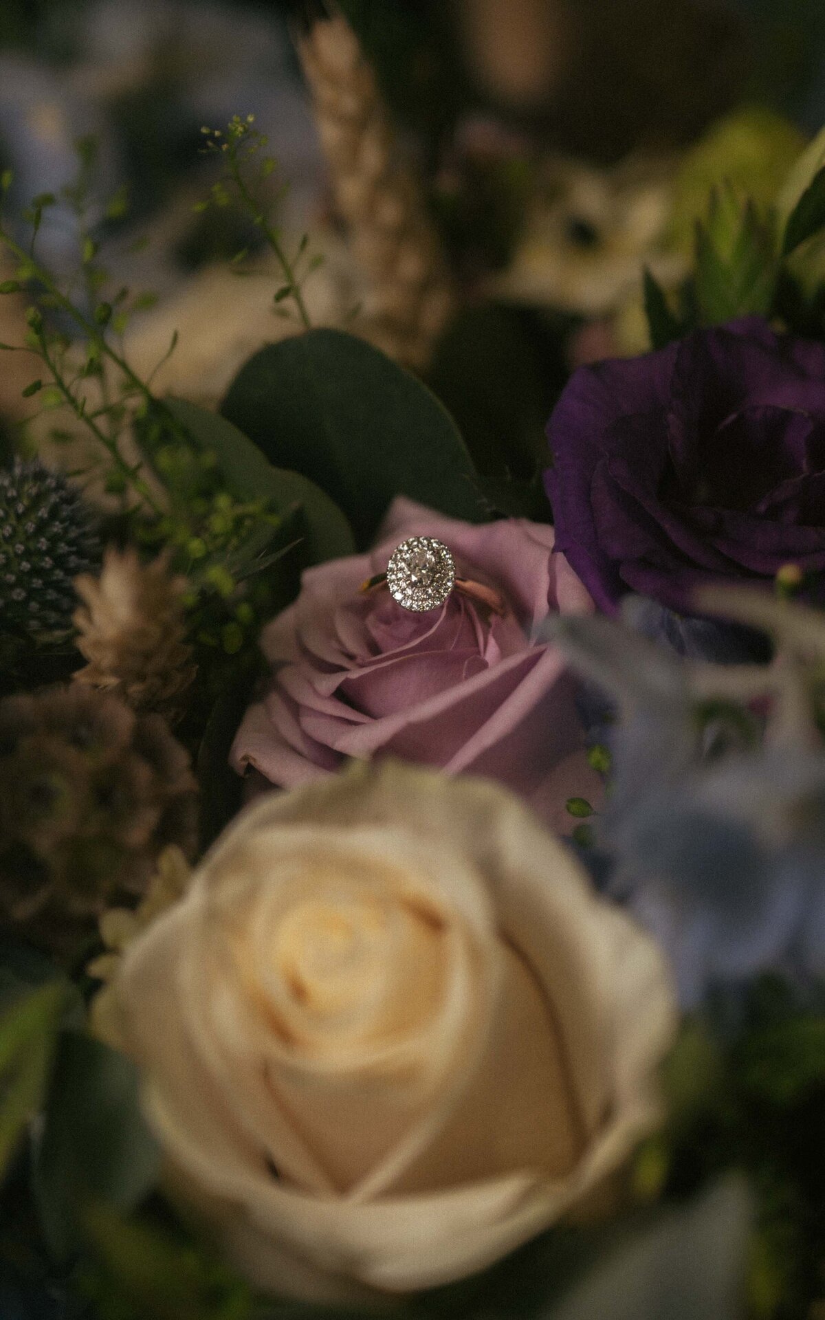 Romantic wedding ring arrangement with seasonal flowers.