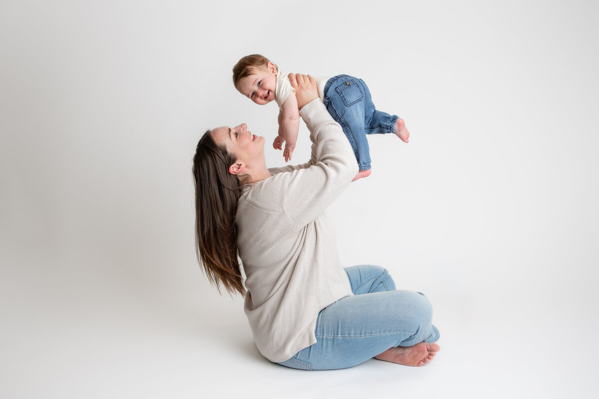 Mom and son on a simple white savage backdrop