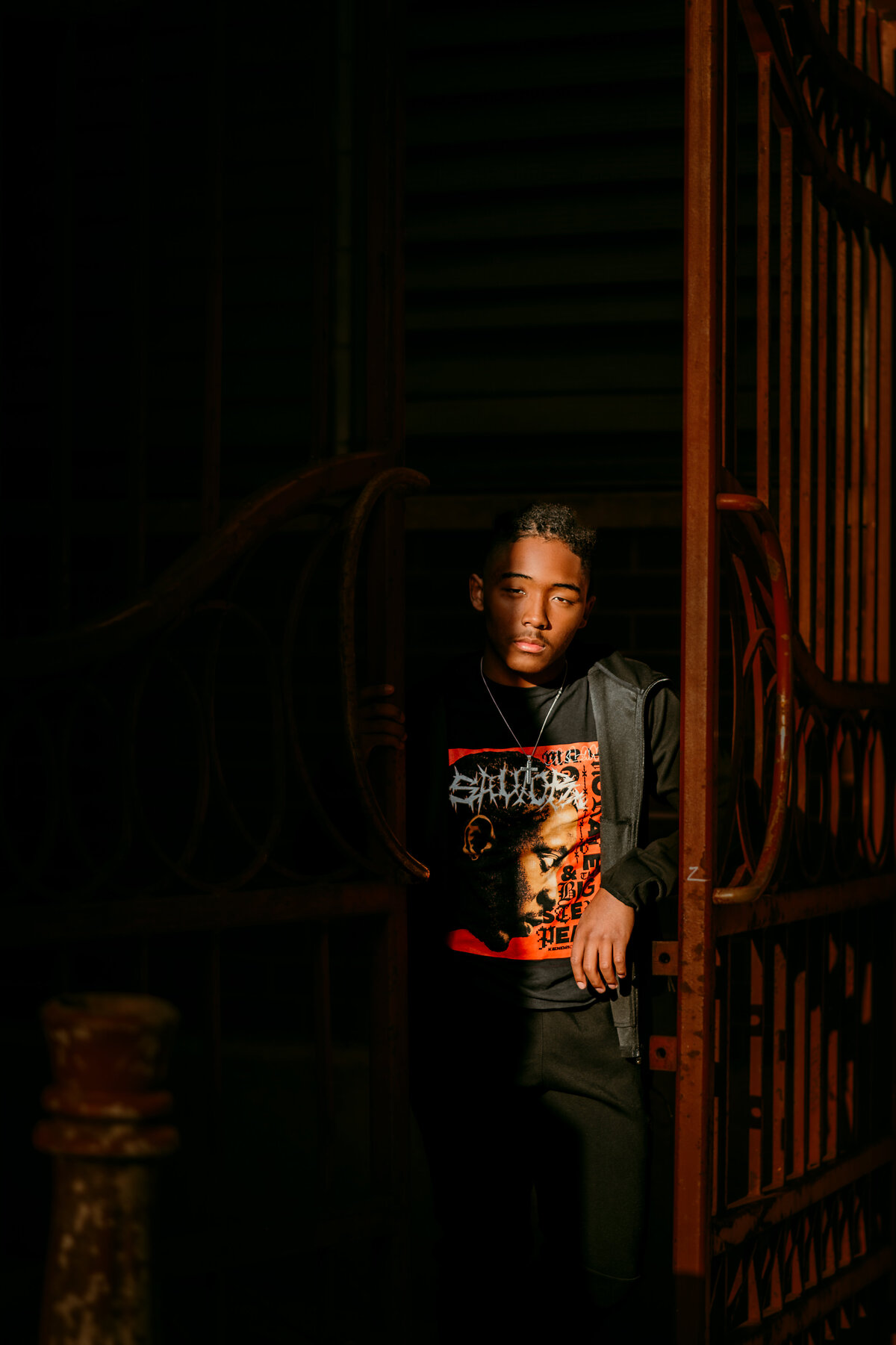 young man peeking out from the shadows in downtown St. Paul, MN