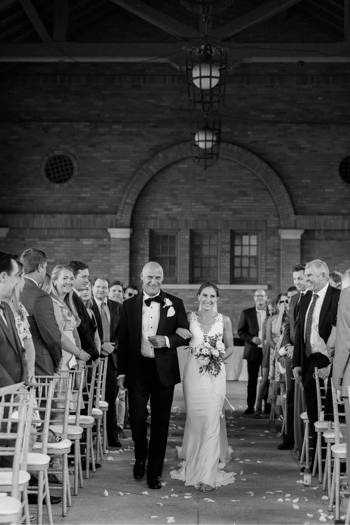 Father of the bride walking bride down the aisle at Columbus Park Refectory for a Luxury Chicago Outdoor Historic Wedding Venue.