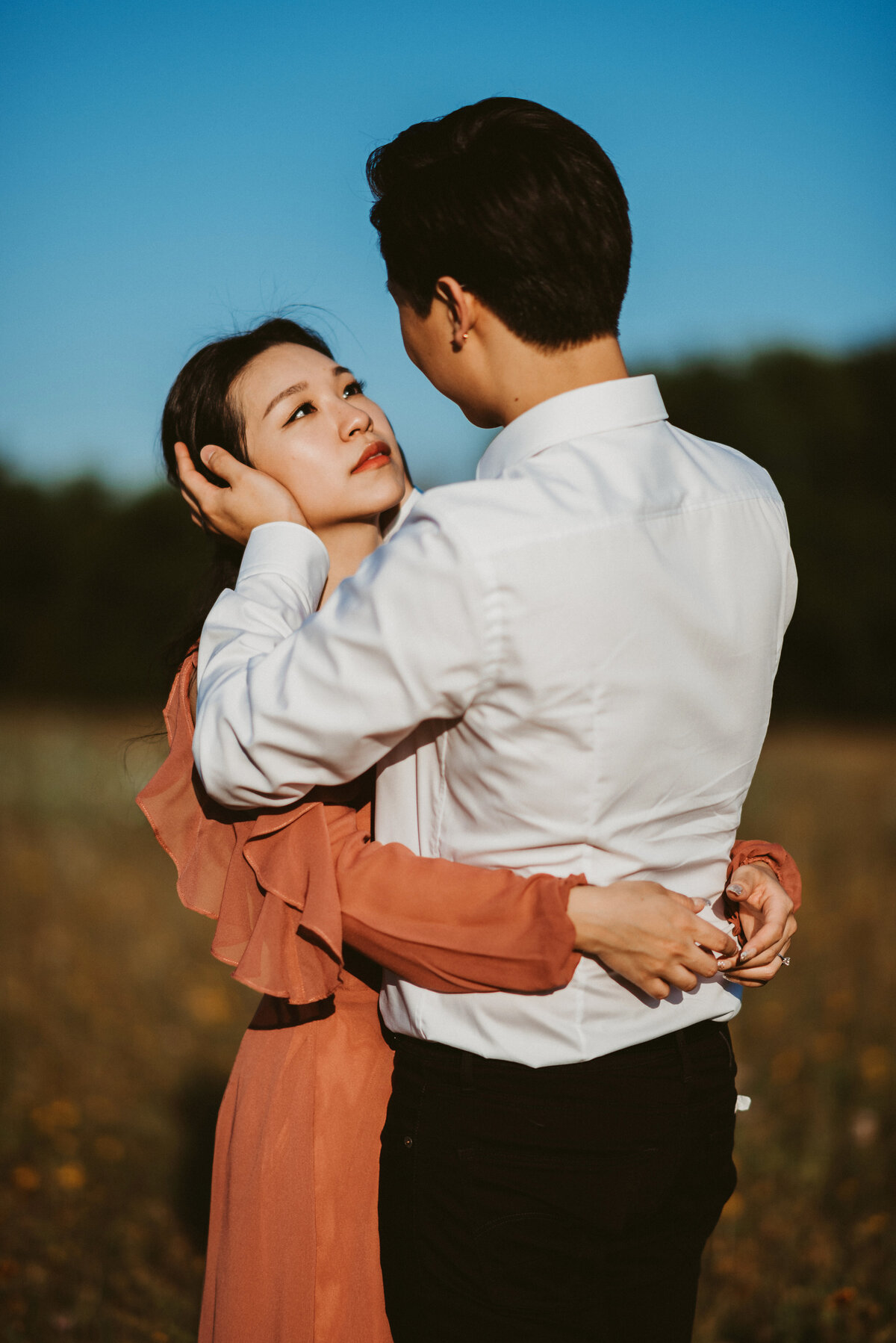 woman looking into partners eyes in field