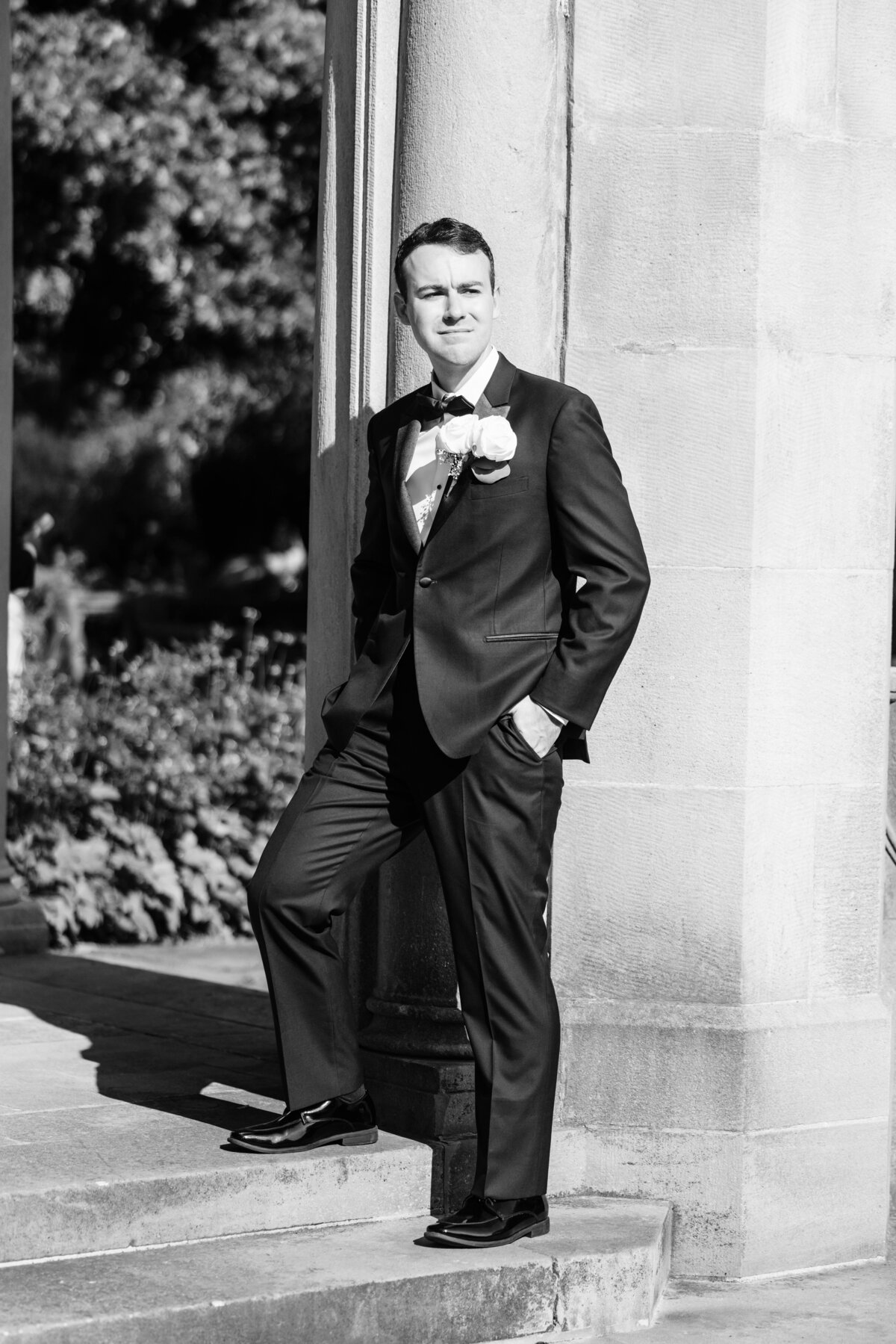 Groom standing on steps at Long Island wedding